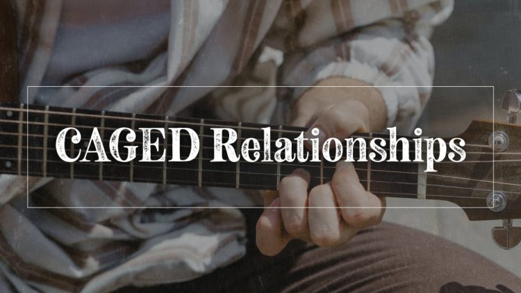 Guy playing the D shape caged chord on guitar